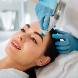 Delighted nice woman enjoying the hydrafacial procedure HydraFacial